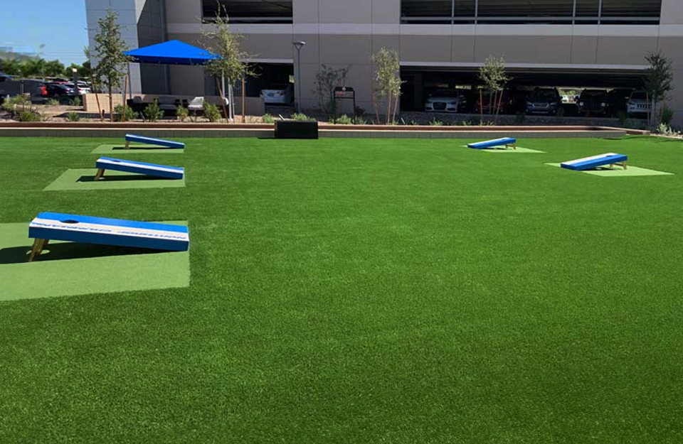 Artificial grass lawn for events featuring cornhole boards